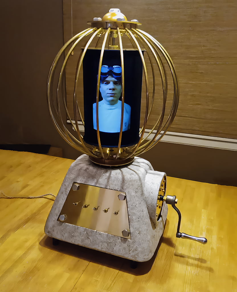 Version 1 Andotrope, which looks like Gehn's Imager from the video game Riven: The Sequel to Myst. It's displaying Mike Ando, the creator of Andotropes.